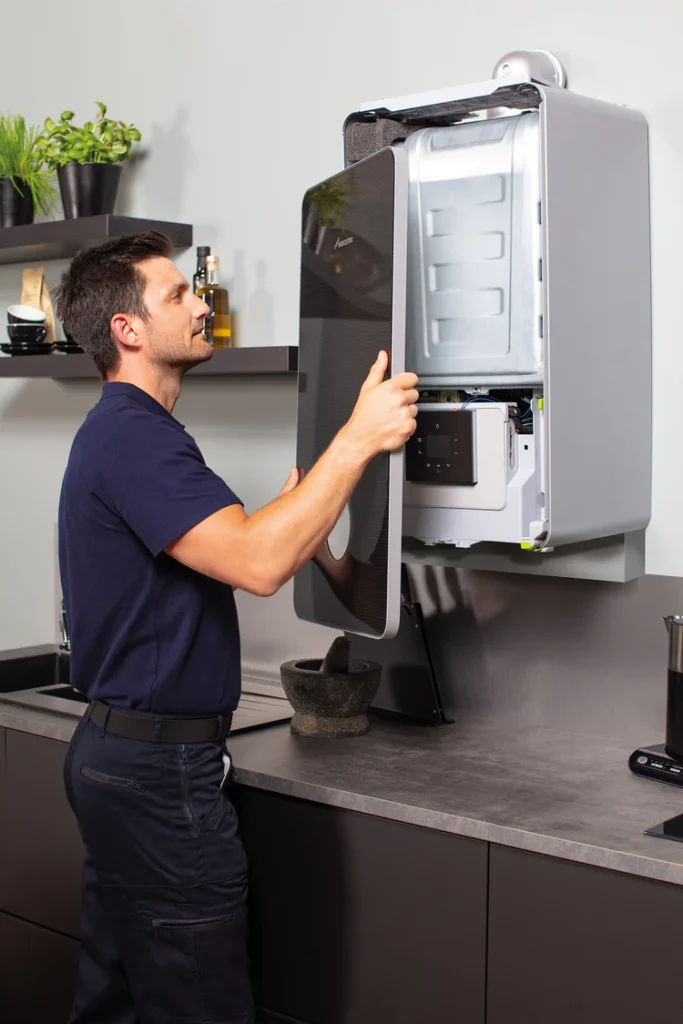Technician Inspecting Modern Wall Boiler