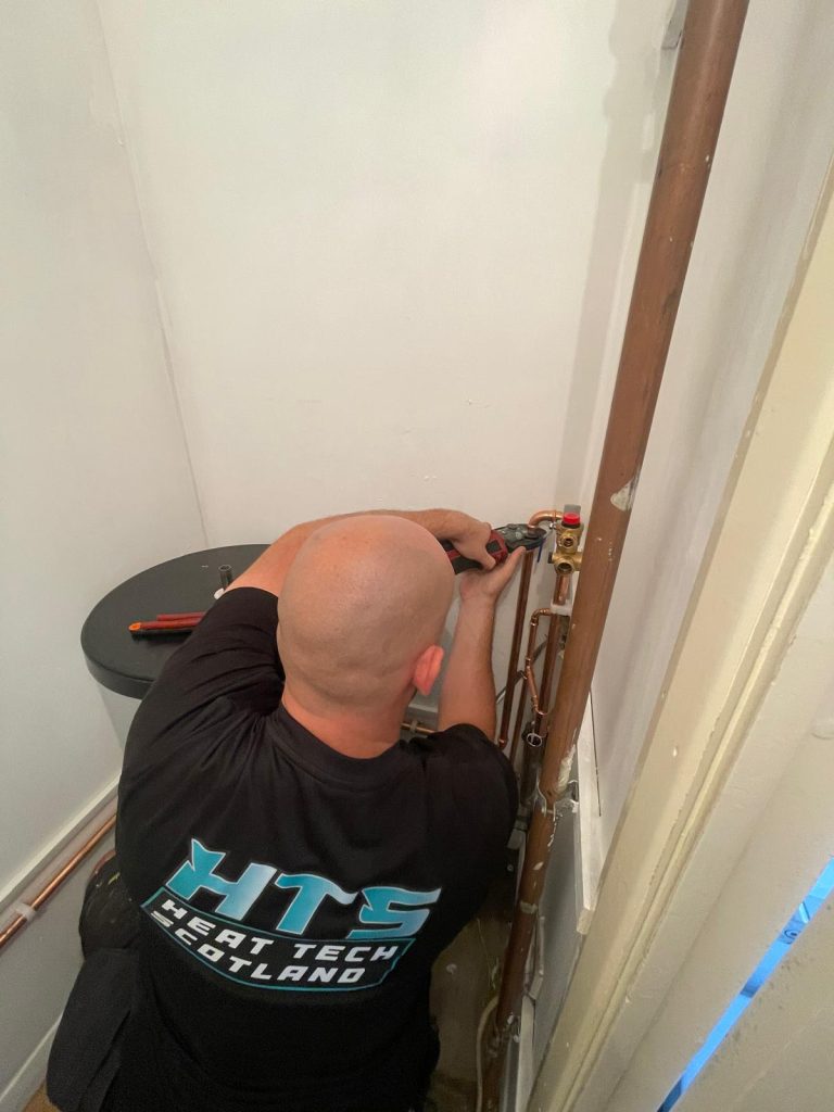 Plumbing Engineer Repairing Wall Pipework
