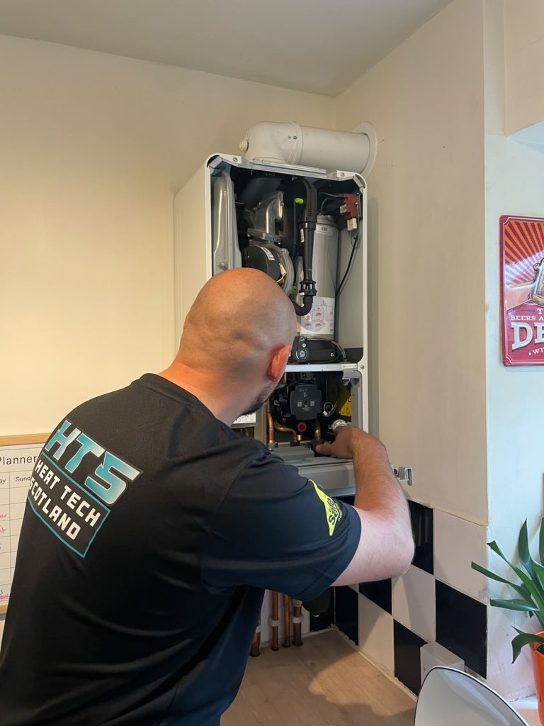 Gas Safe Engineer Repairing Boiler Unit